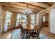 Cozy dining room features a wood table, wood floors, and lots of natural light at 2092 Winwood Farm Rd, Creedmoor, NC 27522