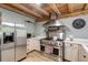 This kitchen features stainless steel appliances, light cabinetry, and a stainless steel vent hood at 2092 Winwood Farm Rd, Creedmoor, NC 27522