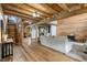 Spacious living room boasts wood plank ceiling, walls, staircase and neutral colored furniture at 2092 Winwood Farm Rd, Creedmoor, NC 27522