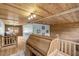 Living room showcasing a wooden ceiling, wood staircase and floors, and an antique-style desk at 2092 Winwood Farm Rd, Creedmoor, NC 27522