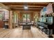Spacious living room featuring a rustic interior, natural light, and a piano at 2092 Winwood Farm Rd, Creedmoor, NC 27522