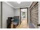 This mud room features coat hooks, storage bins, a bench, and a peek into the laundry room at 2092 Winwood Farm Rd, Creedmoor, NC 27522