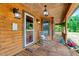 Inviting log cabin porch with rocking chair and rustic decor, creating a cozy and welcoming outdoor space at 2092 Winwood Farm Rd, Creedmoor, NC 27522