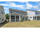 This home features a gray exterior, a screened porch, and a lawn at 2100 Curry Meadow Way, Durham, NC 27703