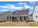This home features a gray exterior, a screened porch, and a lawn at 2100 Curry Meadow Way, Durham, NC 27703