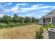 The backyard has a lawn, a treeline, and access to the screened porch at 2100 Curry Meadow Way, Durham, NC 27703