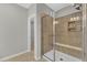 Modern bathroom with a tiled shower with a glass door and a built-in seat at 2100 Curry Meadow Way, Durham, NC 27703