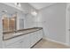 Bathroom with a granite countertop, white cabinets and a large mirror at 2100 Curry Meadow Way, Durham, NC 27703