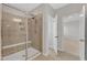 Modern bathroom with a tiled shower with a glass door and a built-in seat at 2100 Curry Meadow Way, Durham, NC 27703