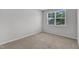 This bedroom features neutral carpet, a window with blinds, and fresh paint at 2100 Curry Meadow Way, Durham, NC 27703