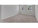 Bright bedroom with carpeted floors and two windows, offering plenty of natural light at 2100 Curry Meadow Way, Durham, NC 27703