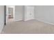 Bedroom showing carpeted floor, closet and connected utility room with neutral color at 2100 Curry Meadow Way, Durham, NC 27703