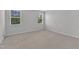 Bedroom featuring carpeted floor and two windows, offering plenty of natural light at 2100 Curry Meadow Way, Durham, NC 27703