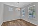 Dining room with wood floors, a chandelier, and bright natural light at 2100 Curry Meadow Way, Durham, NC 27703