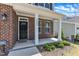 Close-up of a home's entryway, featuring a brick facade and black front door at 2100 Curry Meadow Way, Durham, NC 27703