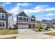Two-story house with a brick veneer, two-car garage, and lush green lawn at 2100 Curry Meadow Way, Durham, NC 27703