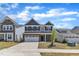 Two-story house with a brick veneer, two-car garage, and lush green lawn at 2100 Curry Meadow Way, Durham, NC 27703