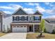Charming two-story home with a brick facade, two-car garage, and manicured front yard at 2100 Curry Meadow Way, Durham, NC 27703