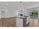 Open concept living space with fireplace and sliding glass doors to screened porch at 2100 Curry Meadow Way, Durham, NC 27703