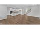 Open-concept area reveals hardwood floors, a kitchen, and a staircase at 2100 Curry Meadow Way, Durham, NC 27703