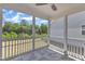 The screened porch has tile flooring, white railings, and views of the backyard at 2100 Curry Meadow Way, Durham, NC 27703