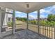 Relax on the screened porch with tile flooring, white railings, and a ceiling fan at 2100 Curry Meadow Way, Durham, NC 27703