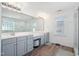 Spacious bathroom featuring double sink vanity, large mirror, and walk-in shower at 2121 Karns Pl, Raleigh, NC 27614