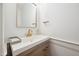 Close-up of a stylish bathroom sink with white countertop, gold faucet, and wood vanity at 2121 Karns Pl, Raleigh, NC 27614