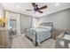 Neutral bedroom with a ceiling fan, light-filled windows and comfortable furnishings at 2121 Karns Pl, Raleigh, NC 27614