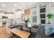Bright breakfast nook with banquette seating, bench, modern light fixture, and views to kitchen at 2121 Karns Pl, Raleigh, NC 27614