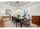 Elegant dining room featuring stylish table, chairs, modern chandelier, and staircase views at 2121 Karns Pl, Raleigh, NC 27614