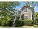 Charming two-story home featuring a shake shingle exterior, white trim, and a well-manicured landscaped front yard at 2121 Karns Pl, Raleigh, NC 27614