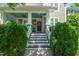 Inviting front porch with white columns, a ceiling fan, and a decorative paw print on the front door at 2121 Karns Pl, Raleigh, NC 27614
