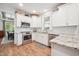 Stylish kitchen featuring white cabinetry, stainless steel appliances, and a view into the dining area at 2121 Karns Pl, Raleigh, NC 27614