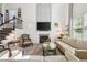 Bright living room with a fireplace, comfortable seating, and a view of the staircase at 2121 Karns Pl, Raleigh, NC 27614