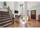 Elegant living room with high ceilings, a fireplace, and a staircase, creating a welcoming atmosphere at 2121 Karns Pl, Raleigh, NC 27614