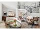 Spacious living room featuring a comfortable seating area, hardwood floors, and a staircase to the upper level at 2121 Karns Pl, Raleigh, NC 27614