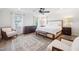 Bright main bedroom featuring a ceiling fan, seating, and natural light at 2121 Karns Pl, Raleigh, NC 27614
