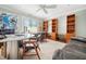 Spacious office with a built-in bookshelf, ceiling fan, lounge area, and modern desk at 2121 Karns Pl, Raleigh, NC 27614