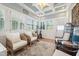Bright sunroom features cozy furniture, many windows, and a calming color palette at 2121 Karns Pl, Raleigh, NC 27614