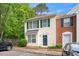 Charming townhome featuring a classic yellow facade with green shutters and a well-manicured front yard at 216 Climbing Ivy Ct, Cary, NC 27511