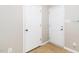 Bright hallway featuring neutral walls, tiled floors, and two white doors at 216 Climbing Ivy Ct, Cary, NC 27511