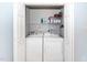 Convenient laundry area featuring a washer, dryer, and storage shelves at 216 Climbing Ivy Ct, Cary, NC 27511