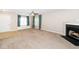 Spacious living room featuring a cozy fireplace and large window with view at 216 Climbing Ivy Ct, Cary, NC 27511