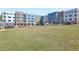 Modern apartment complex with brick and blue siding surrounded by a green lawn at 2418 Gathering Square Ct, Fuquay Varina, NC 27526