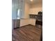 Modern kitchen featuring white cabinets, stainless steel appliances, and granite countertops at 2418 Gathering Square Ct, Fuquay Varina, NC 27526