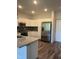 Well-lit kitchen with white cabinets, stainless steel appliances, and granite countertops at 2418 Gathering Square Ct, Fuquay Varina, NC 27526