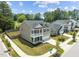 Aerial view showcasing a two-story home, landscaped yard, and neighborhood street at 2501 Macedonia Pine Dr, Raleigh, NC 27616