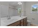 Bathroom featuring double sinks, a large mirror, and a window for natural light and ventilation at 2501 Macedonia Pine Dr, Raleigh, NC 27616