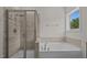Modern bathroom with glass door shower, soaking tub, and sleek fixtures at 2501 Macedonia Pine Dr, Raleigh, NC 27616